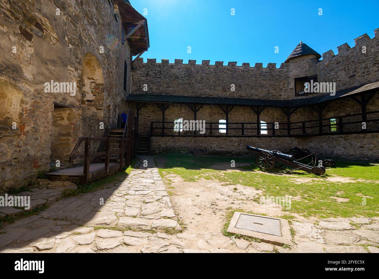 Stara Lubovna, Slovakia - 28 AUG 2016: ancient cannon in the inner courtyard of the castle. great stone walls of a fortrece. popular travel destinatio Stock Photo