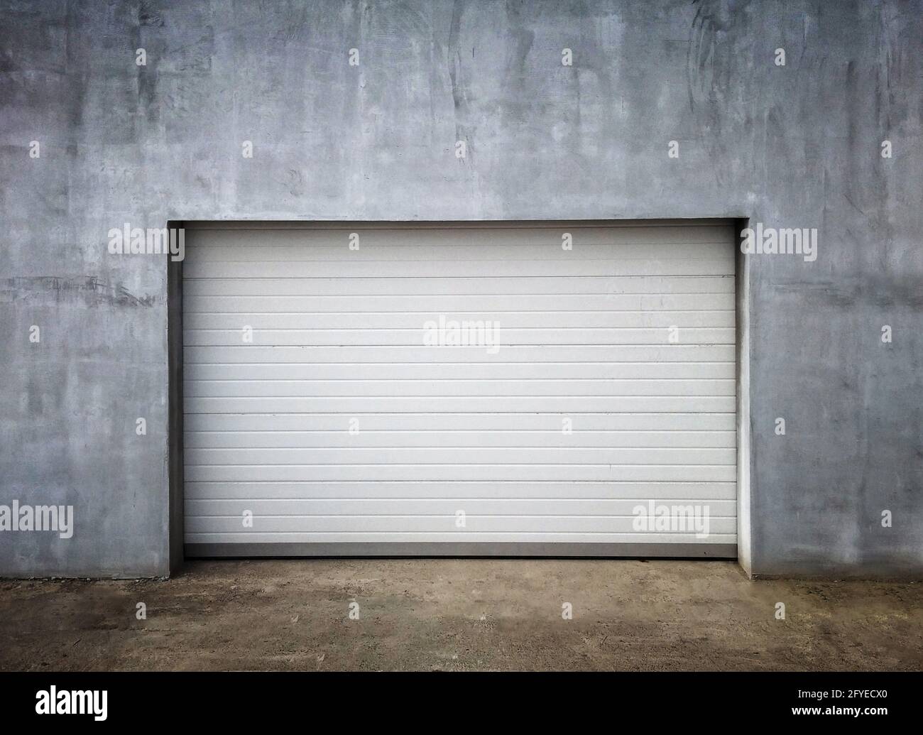 New Modern Garage Door in Unfinish Exterior Concrete Wall Stock Photo