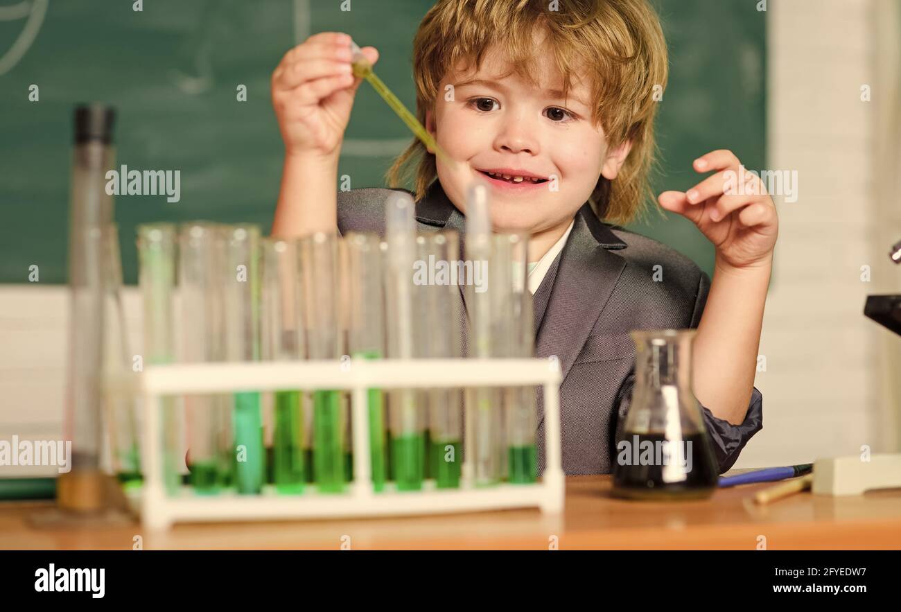 Little boy at elementary school. Biology school laboratory equipment