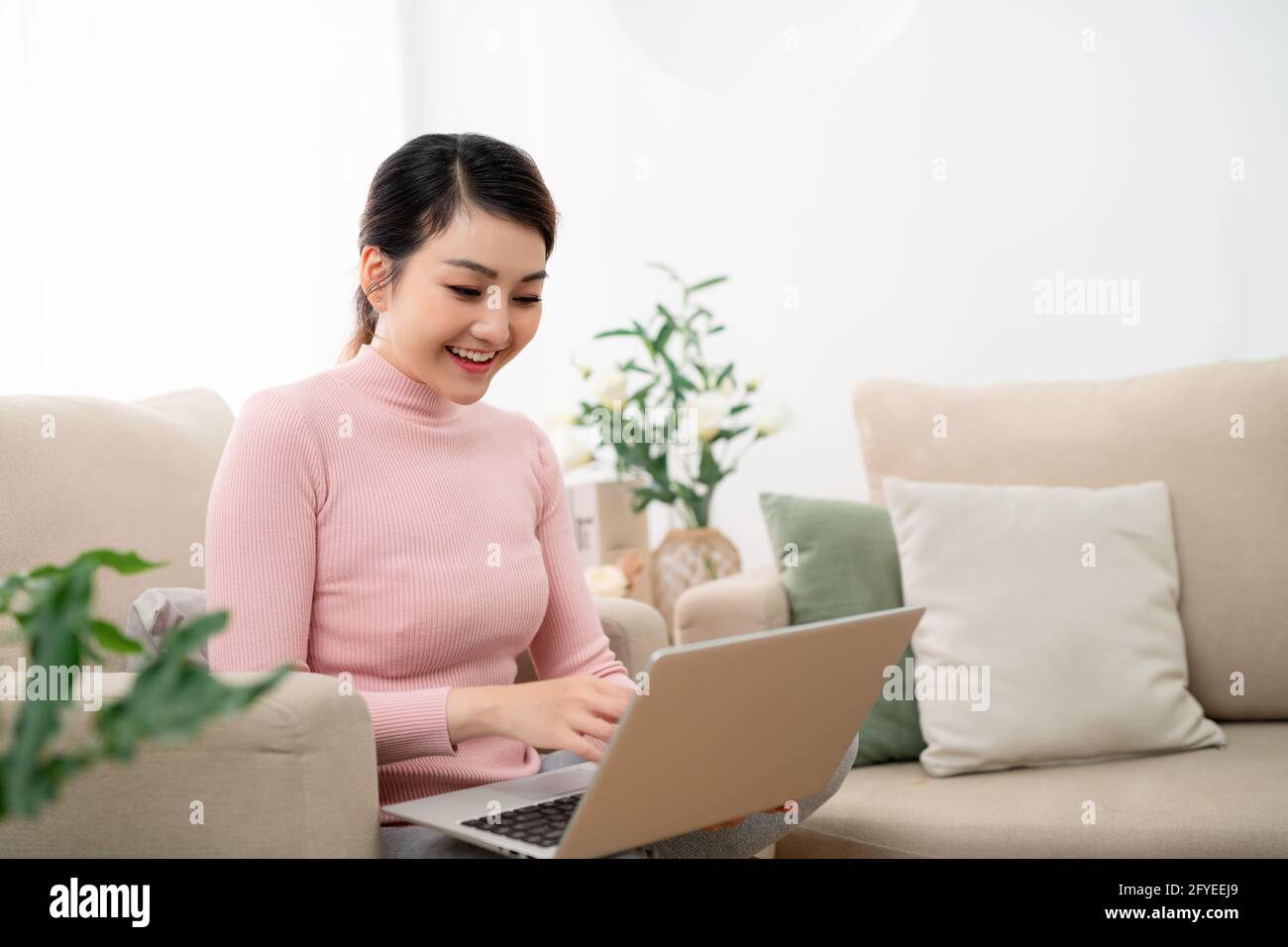 young beautiful woman using a laptop computer at home Stock Photo - Alamy