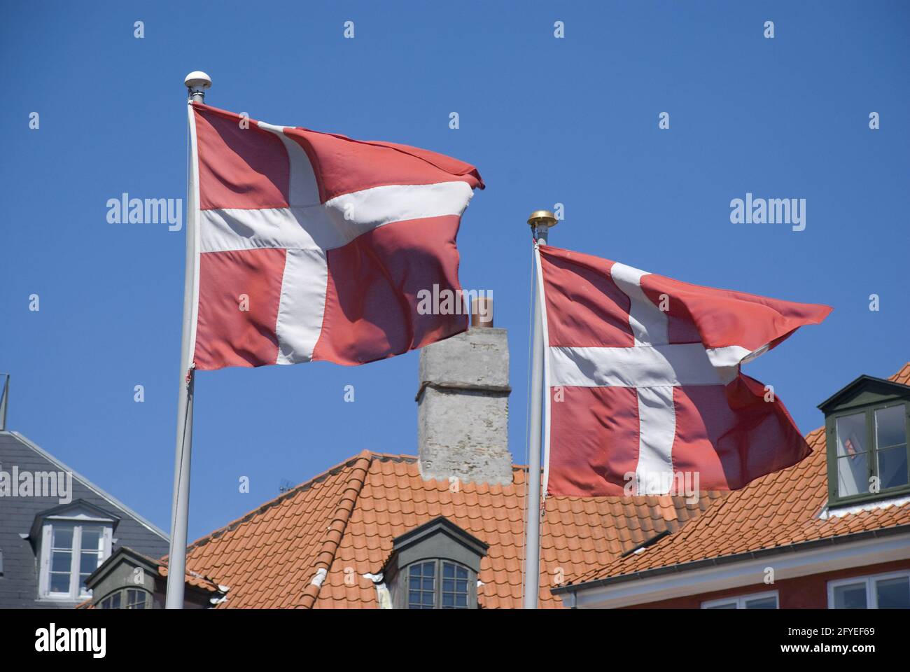 COPENH, DENMARK - Jun 13, 2013: Patriotic Denmark: Danish flag on pole waving in wind Stock Photo