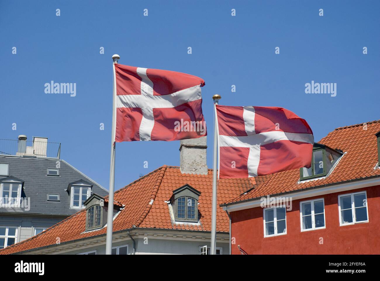 COPENH, DENMARK - Jun 13, 2013: Patriotic Denmark: Danish flag on pole waving in wind Stock Photo