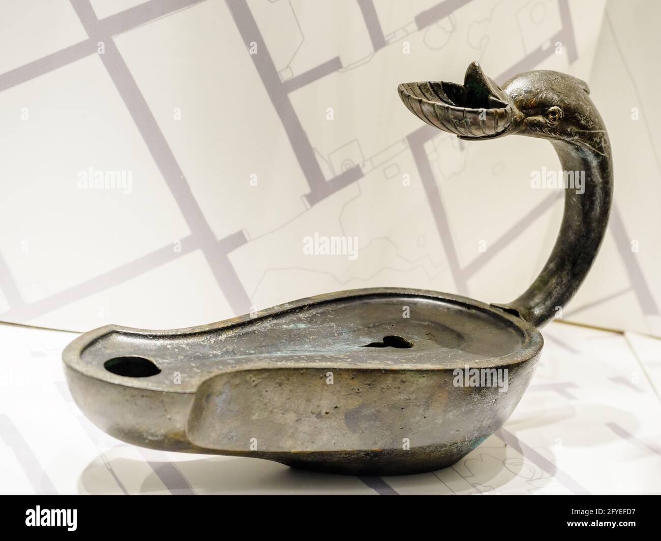 Lucerna con manico raffigurante un delfino (Oil lamp with handle depicting a dolphin) in bronze - Herculaneum ruins, Italy Stock Photo