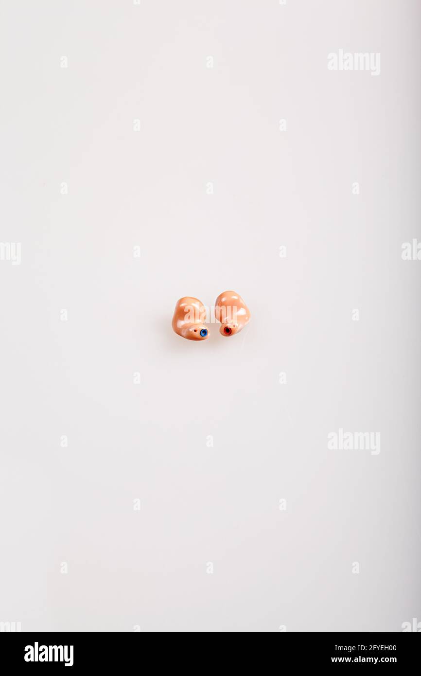 In the ear hearing aids on grey .  Text free space and portrait format Stock Photo