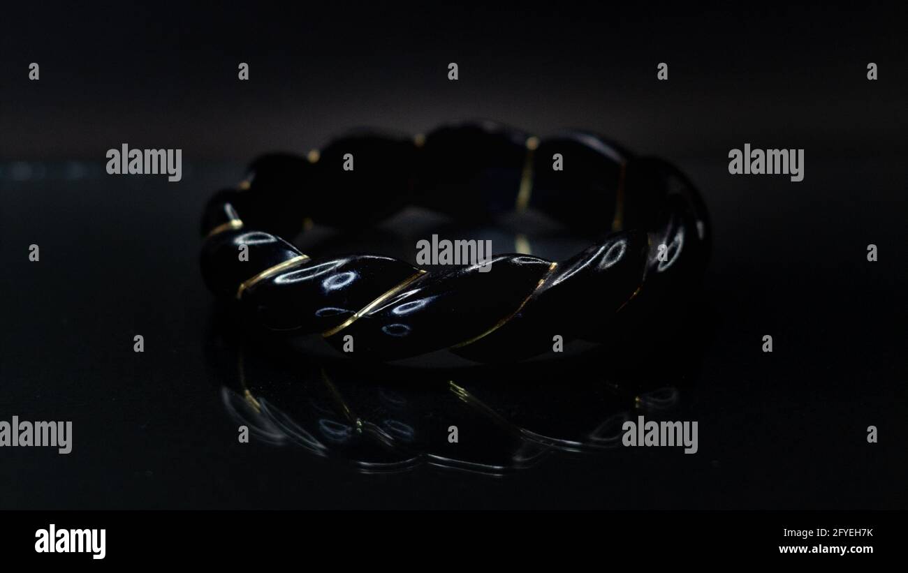 Shot of the black bracelet with black background. Stock Photo