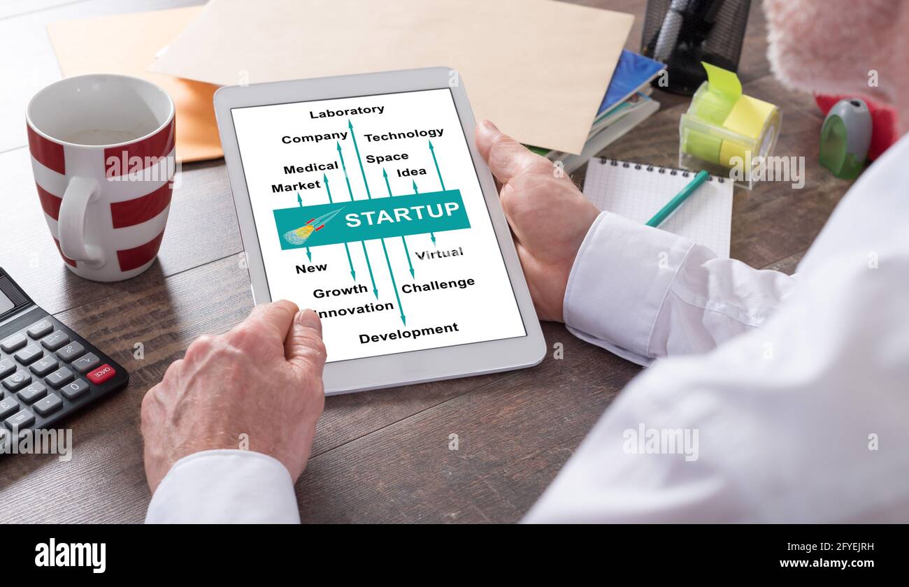 Start up concept shown on a tablet held by a man Stock Photo
