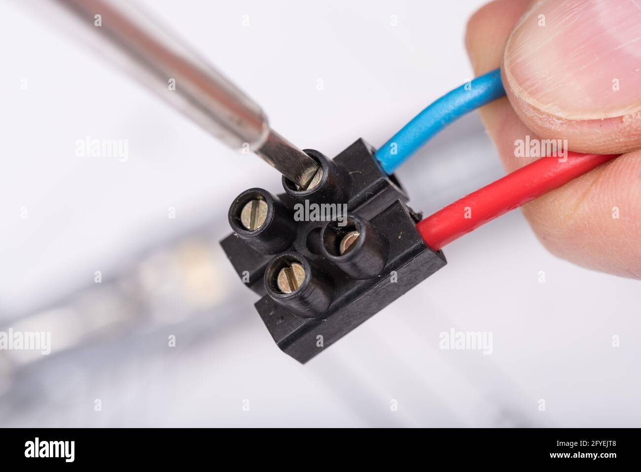 Clamping a wire in a connector, closeup Stock Photo