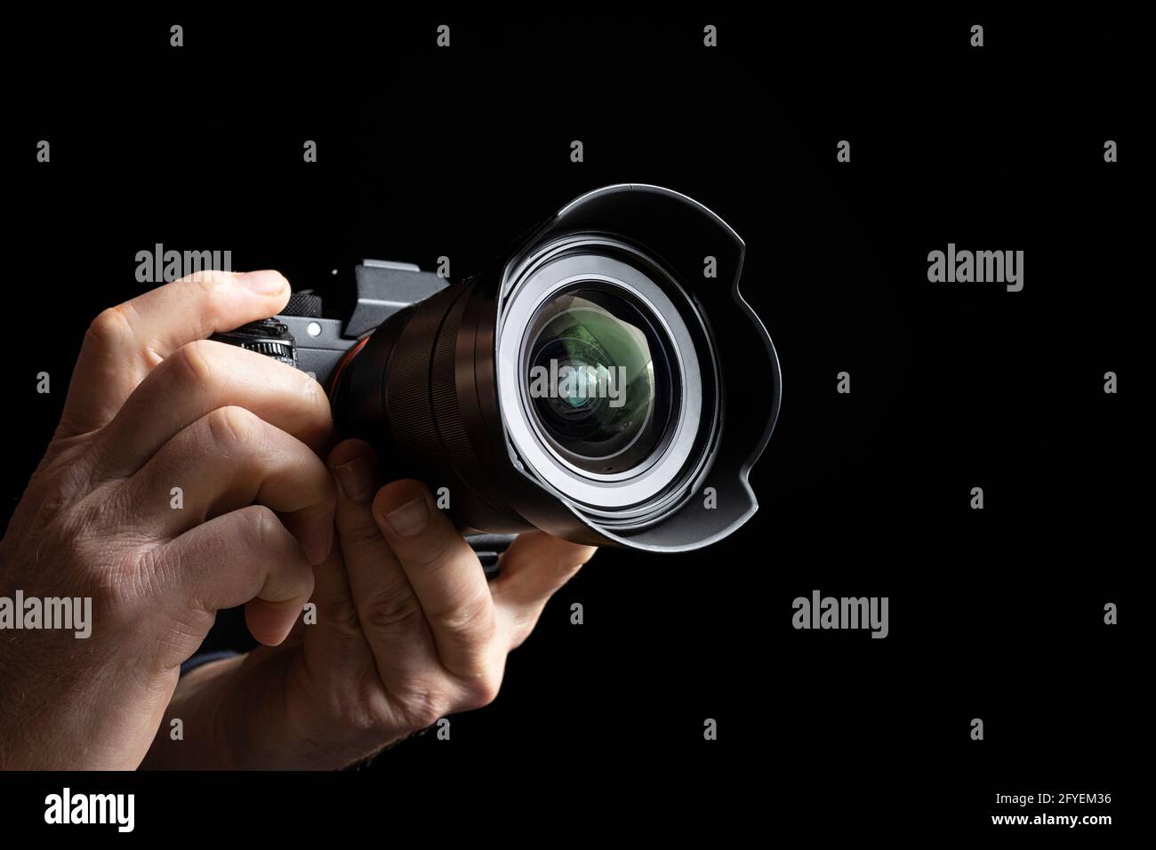 a man holds a camera in his hands Stock Photo