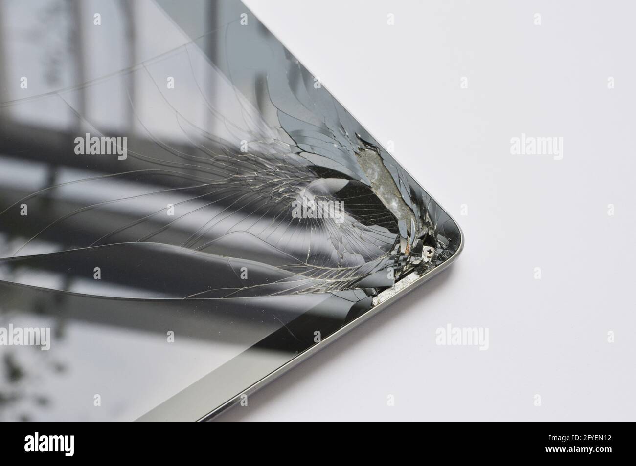 Deep broken hole on the edge of a smart tablet touchscreen Stock Photo