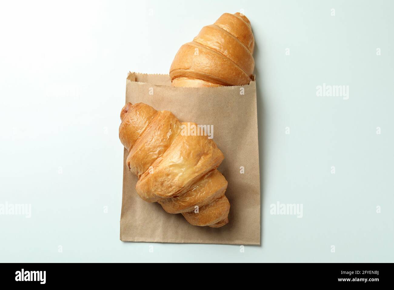 Paper bag with croissants on white background Stock Photo - Alamy