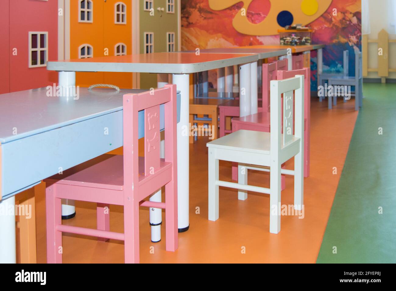 A set of cute children's tables and high chairs in the kindergarten