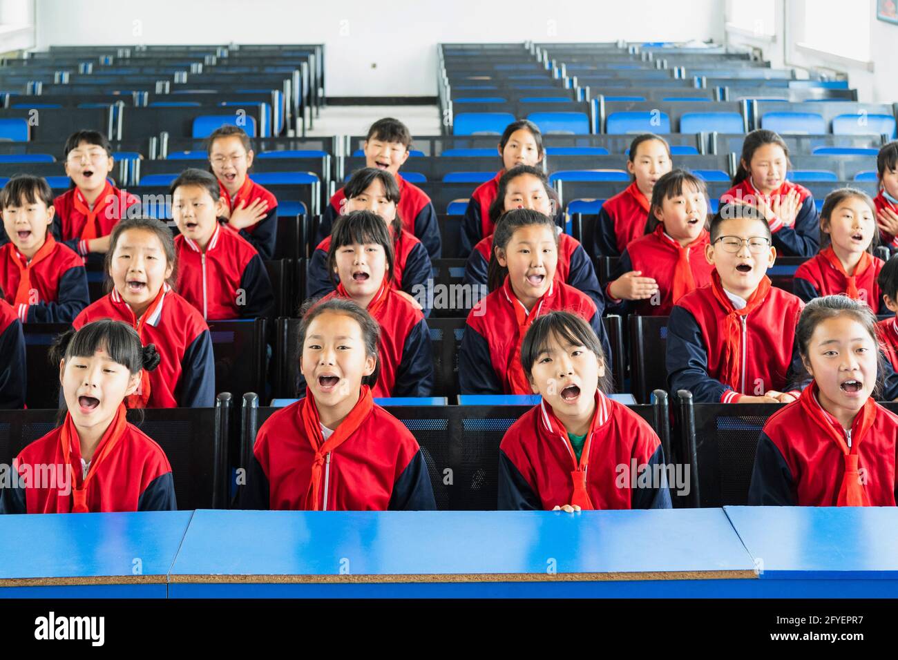(210528) -- HARBIN, May 28, 2021 (Xinhua) -- Children in the music class practice chorus at the Renmin Town Central Primary School in Renmin Town of Anda City, northeast China's Heilongjiang Province, May 25, 2021. Li Ping and Zhang Yu are music teachers of the Renmin Town Central Primary School. In April 2019, they set up a music class in the school.    'Before, when we were teaching music lessons, we found that some children sang very well, so we had the original intention of setting up a music class to train children who love music, and give more rural students the opportunity to learn voca Stock Photo