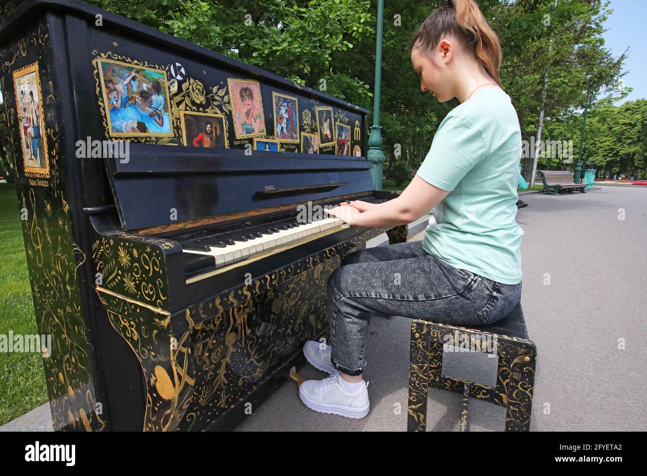 KHARKIV, UKRAINE - MAY 27, 2021 - A woman plays one of the 10 painted pianos  installed as part of the Art Piano project on the street in Kharkiv, nort  Stock Photo - Alamy