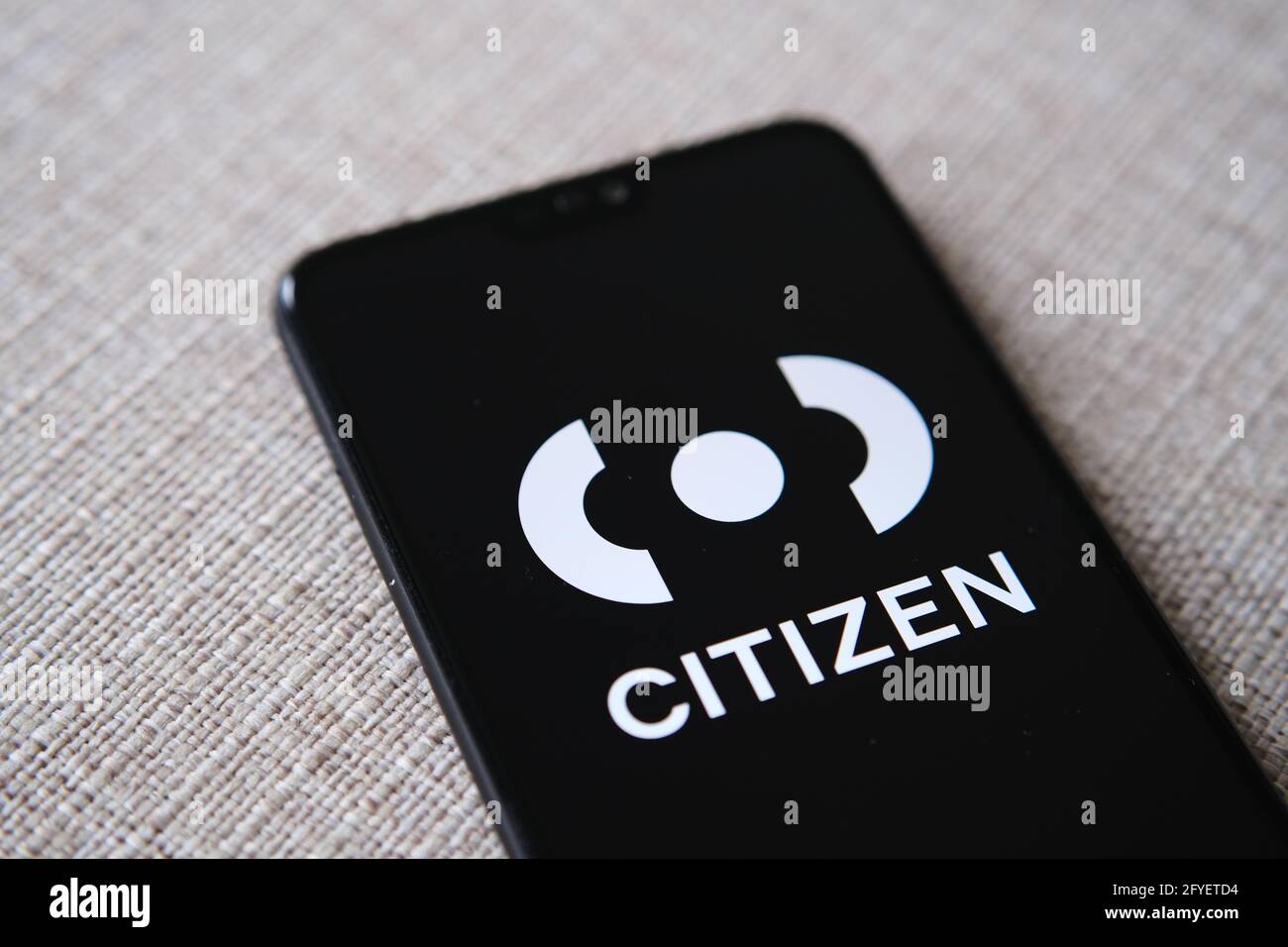 Citizen app login screen seen on smartphone hold in a hand. Citizen app