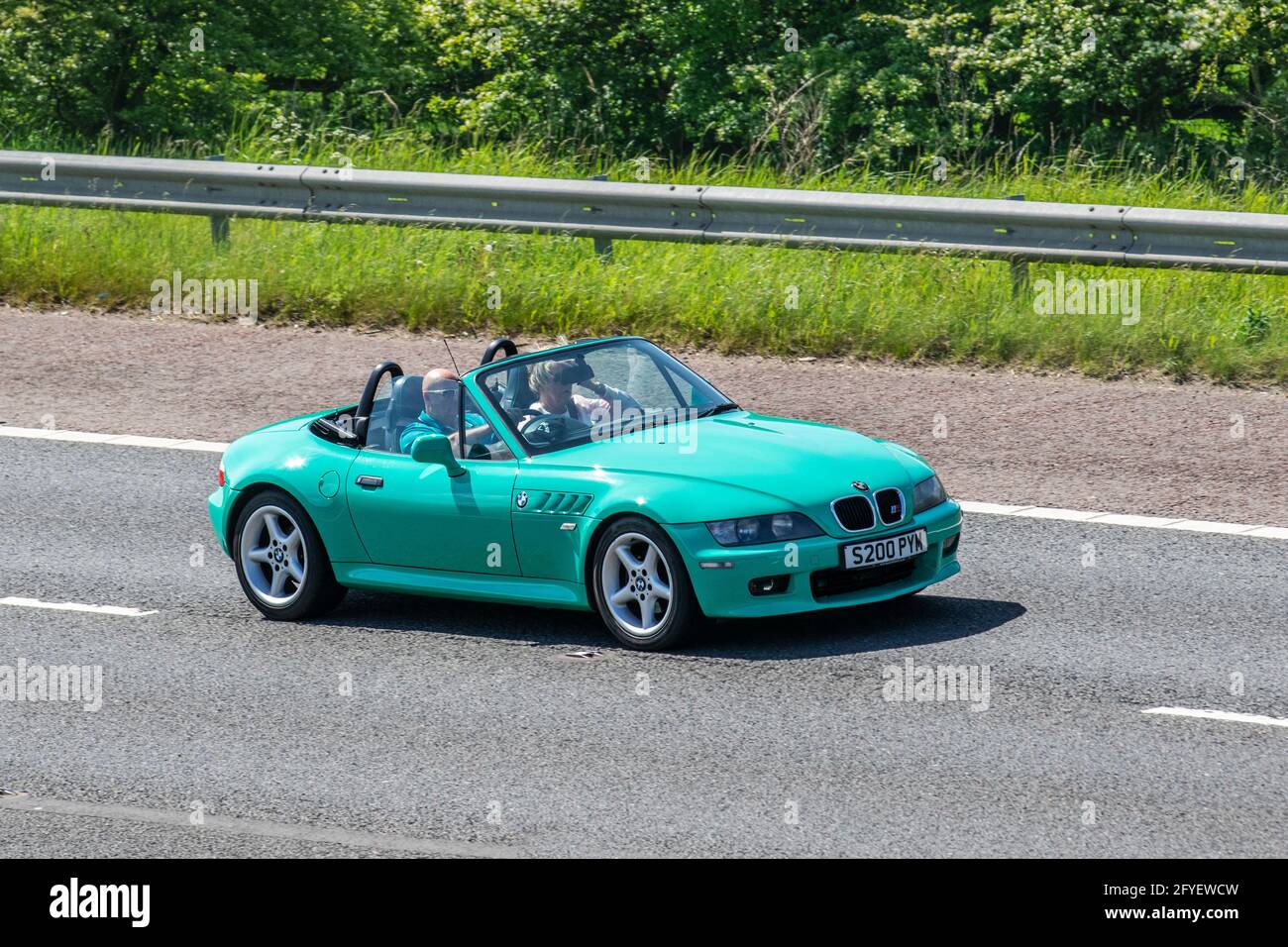1999 90s Green BMW Z3 2793cc roadster; Vehicular traffic, moving vehicles, convertible cars, vehicle driving on UK roads, motors, motoring on the M6 motorway UK road network. Stock Photo