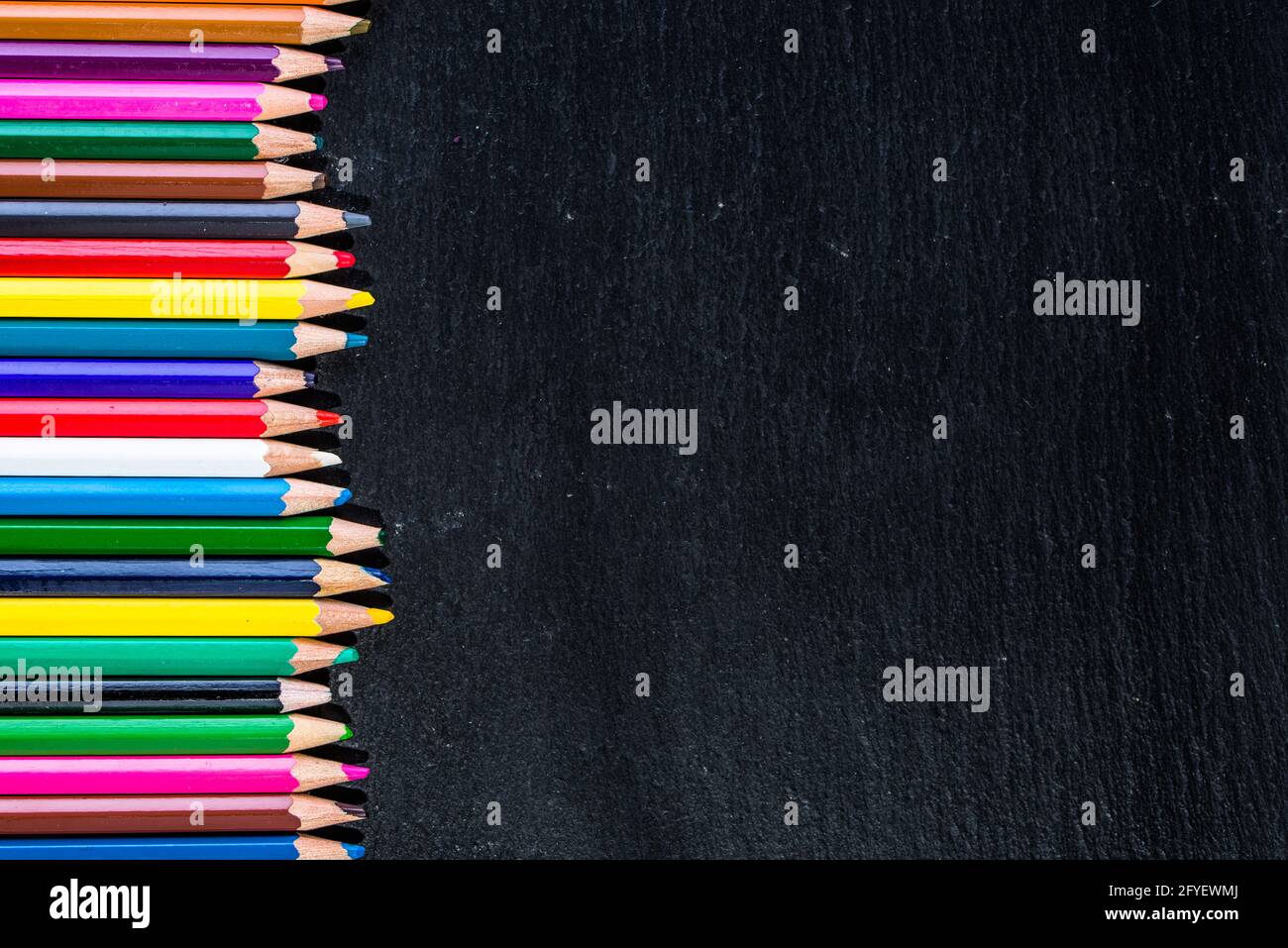 Colorful pencils frame background on black, back to school concept ...