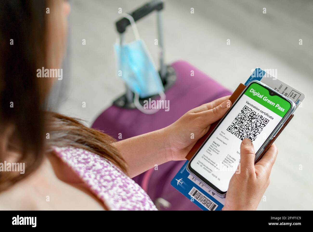 Top view of woman holding id documents and covid vaccination