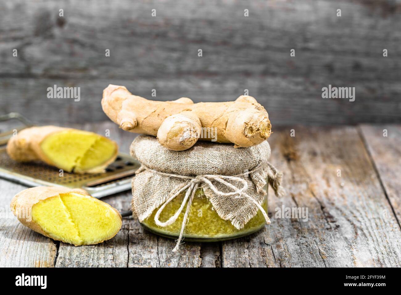 Grated ginger in a glass jar, seasoning ingredients, medicinal spice for self treatment Stock Photo