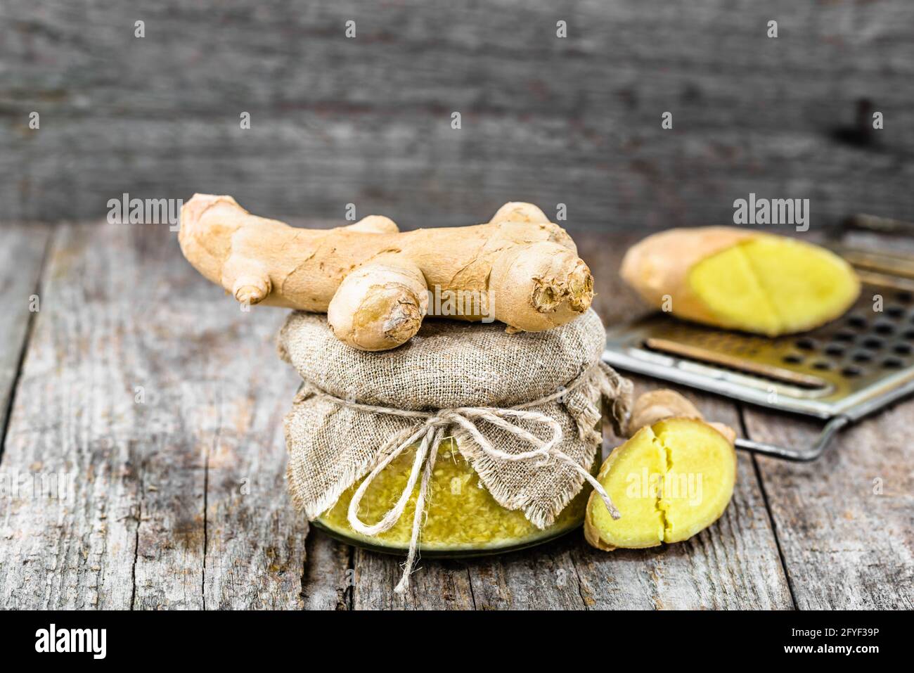Grated ginger in a glass jar, spice for self treatment, seasoning ingredient in cuisine Stock Photo