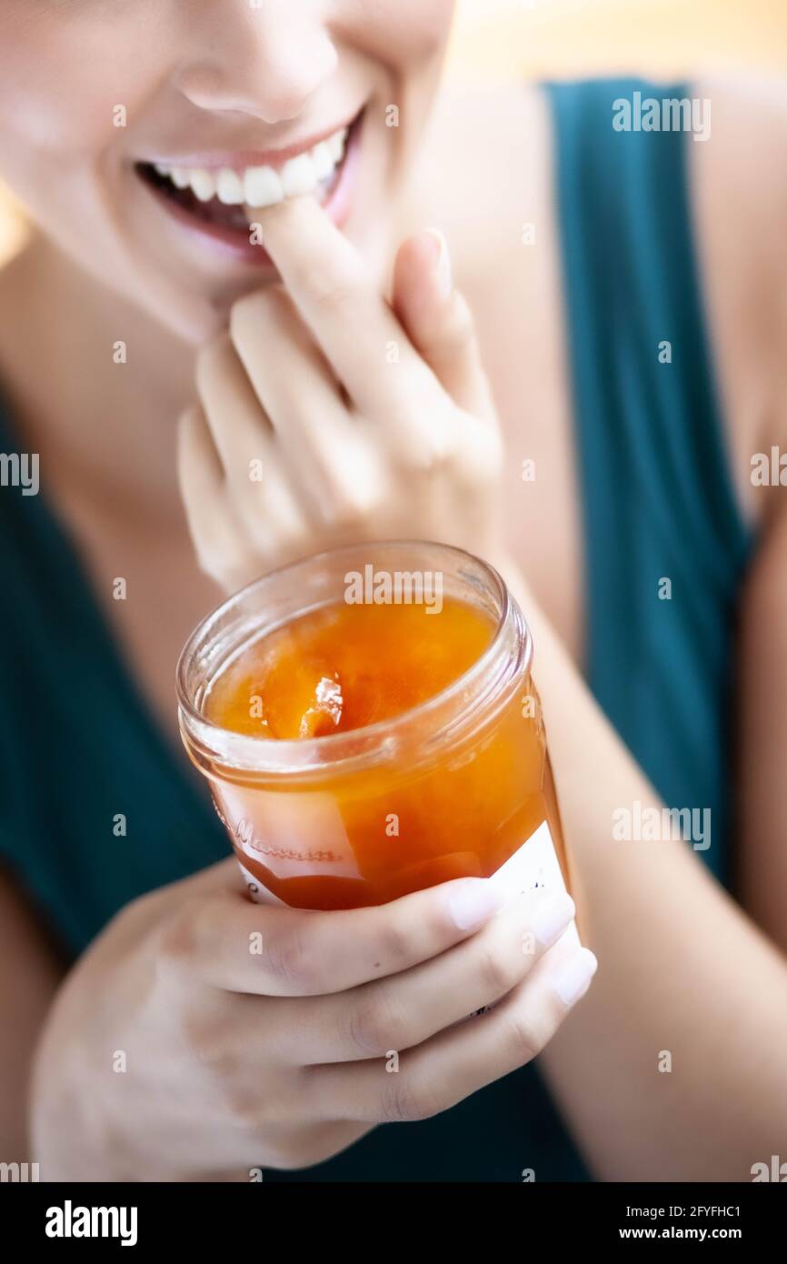 Woman eating jam. Stock Photo