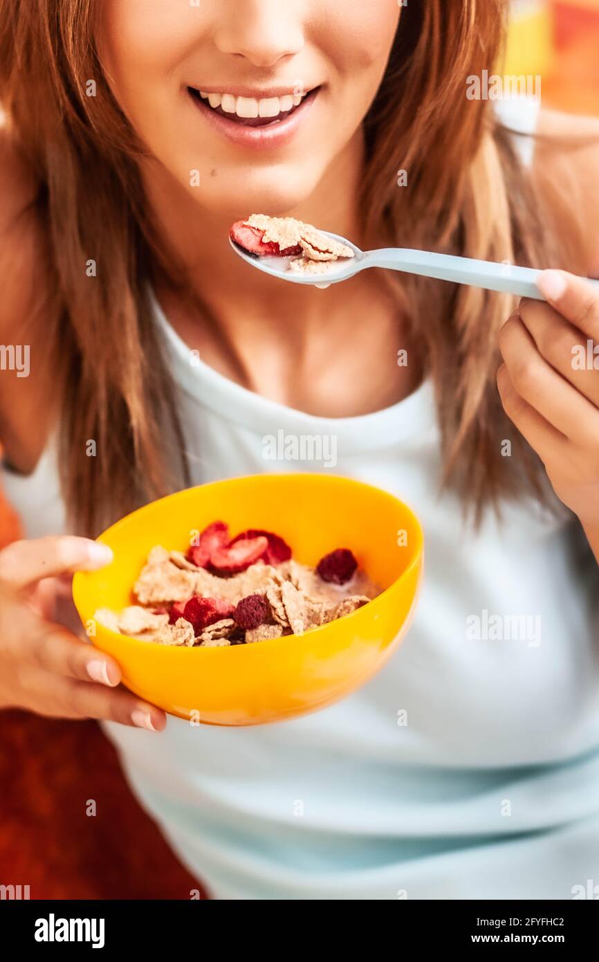 Woman eating cereals. Stock Photo