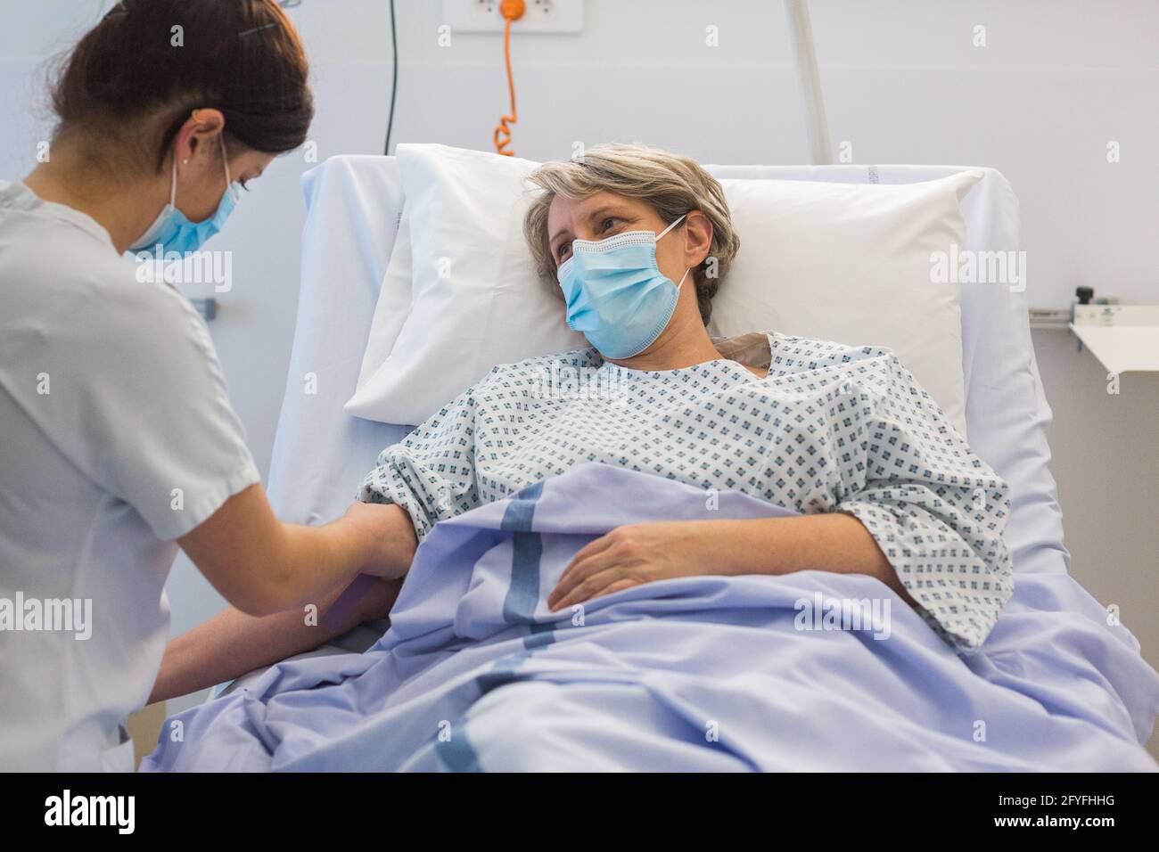 Nurse with an hospitalized patient. Limoges hospital, France.. Stock Photo