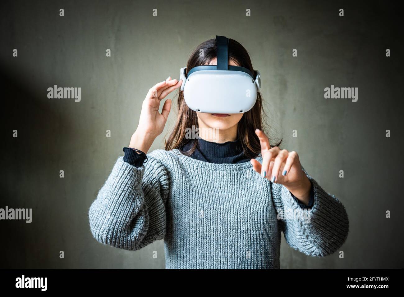 Teenage Girl Using Virtual Reality Oculus Headset. Stock Photo