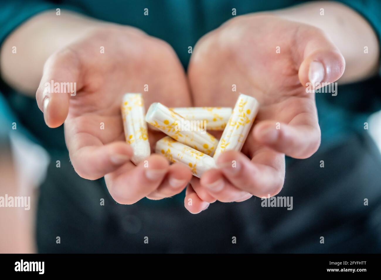 Woman holding tampons. Stock Photo