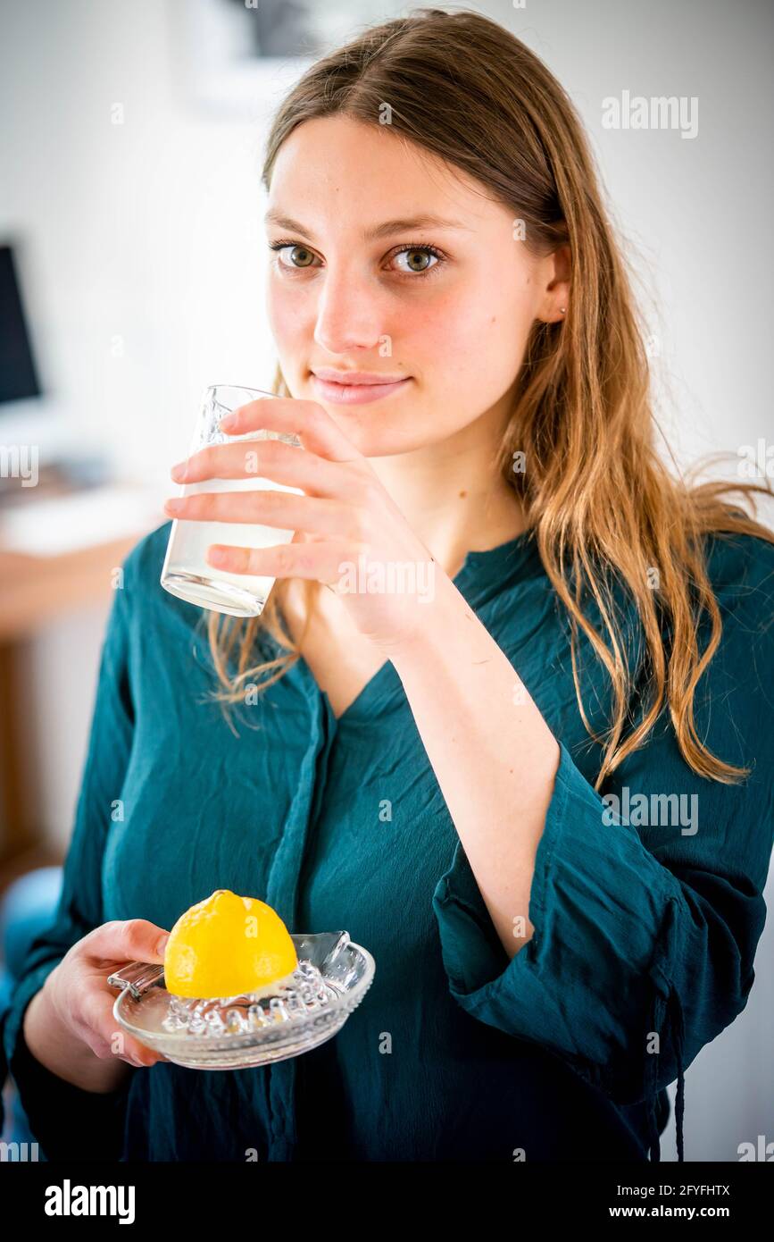 Woman drinking freshly squeezed lemon juice Stock Photo Alamy