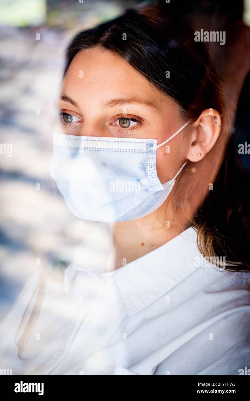 Woman wearing a surgical mask. Stock Photo