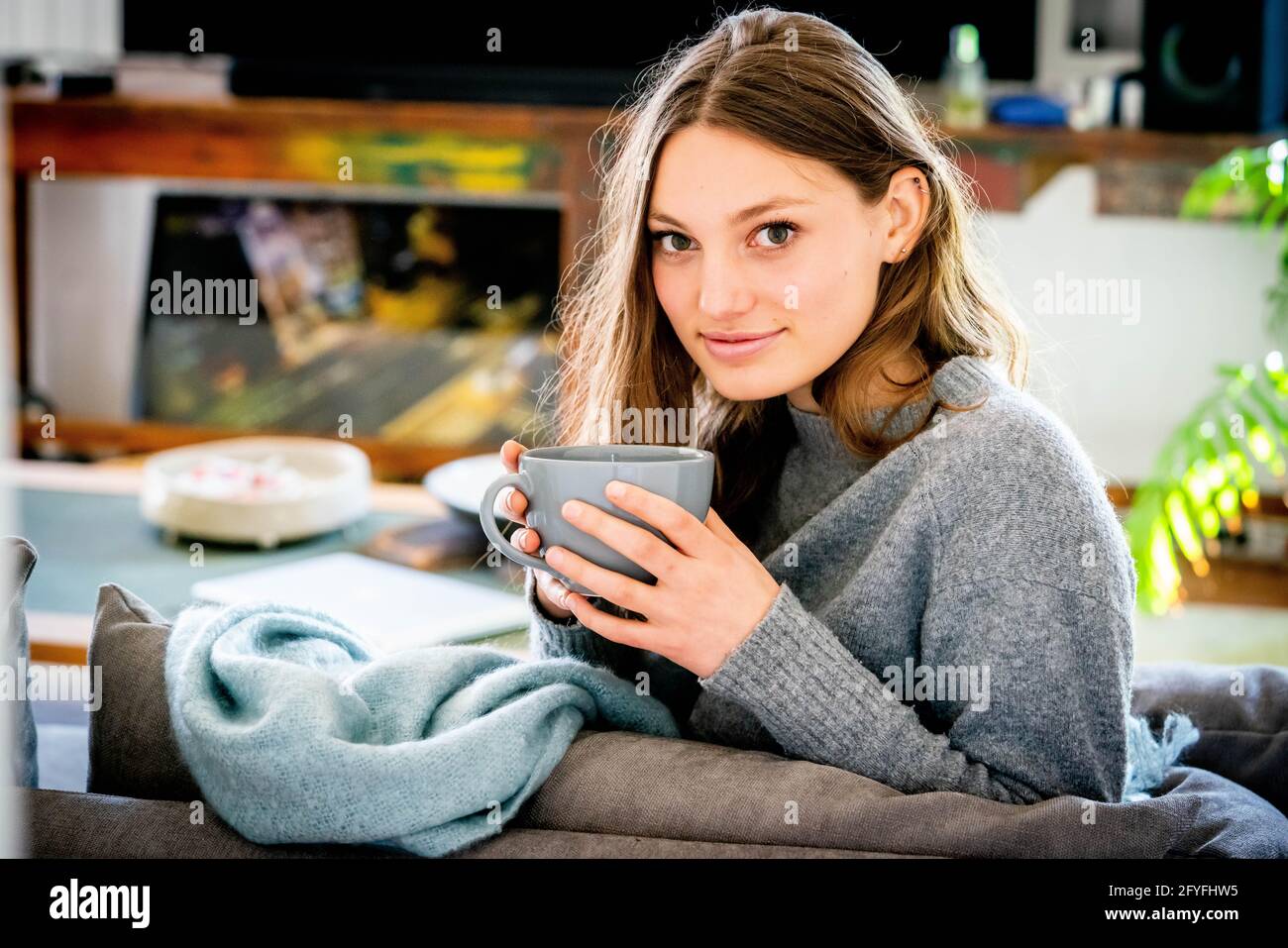 Woman drinking hot beverage. Stock Photo