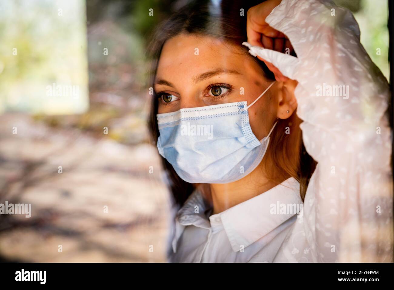 Woman wearing a surgical mask. Stock Photo