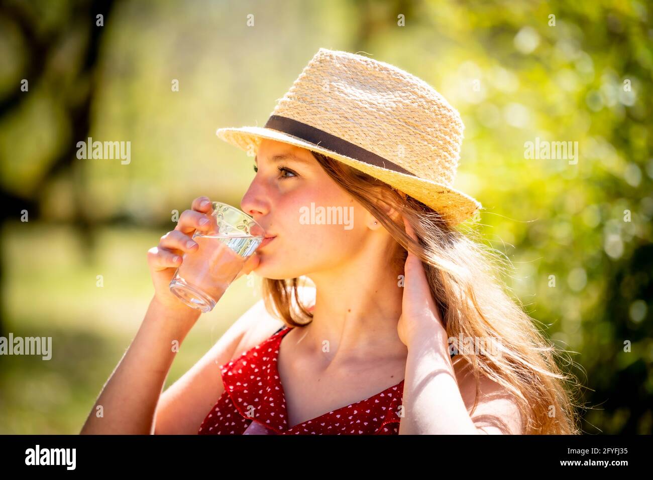 Woman drinking of glass of water. Stock Photo