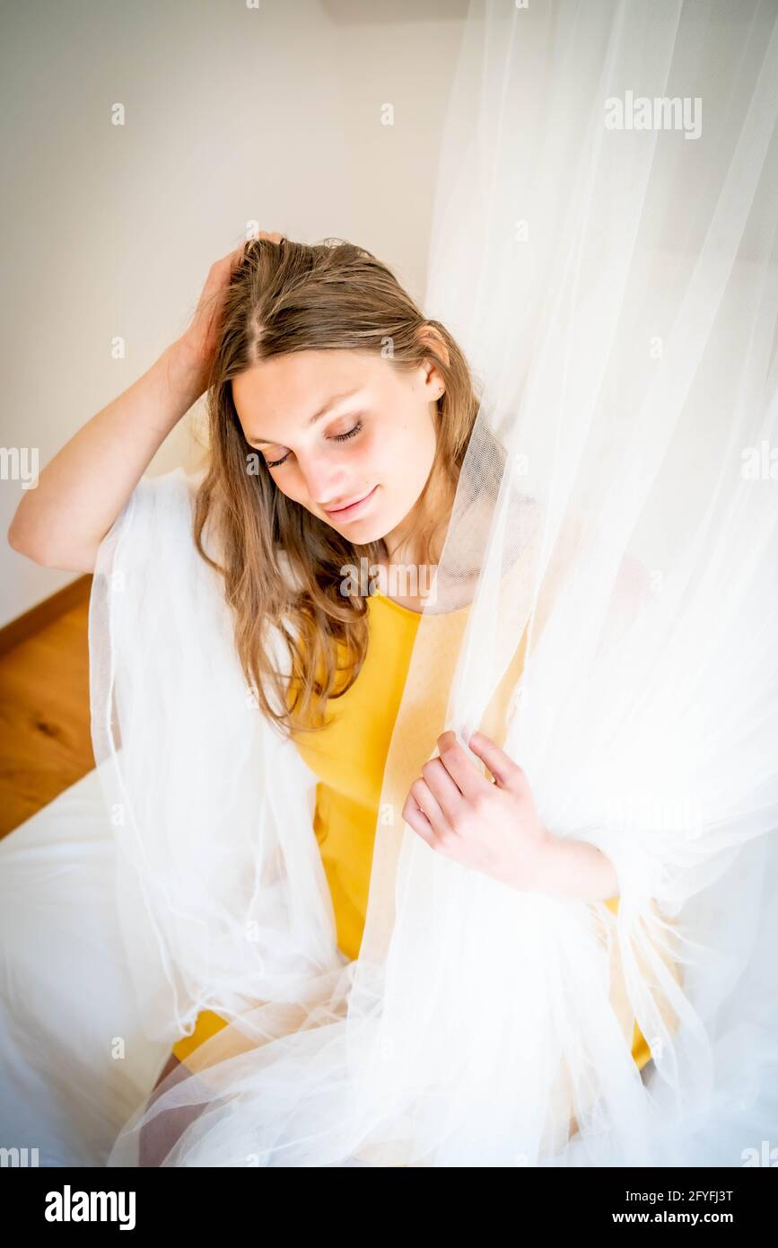 Woman under a mosquito net. Stock Photo