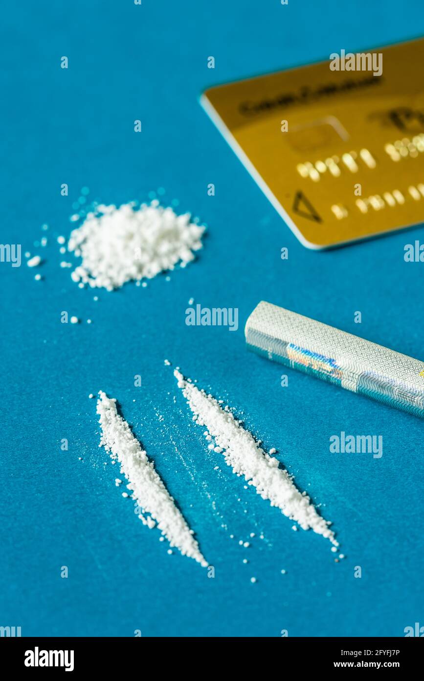 Rolled-up bank note being used to snort a line of cocaine. Stock Photo