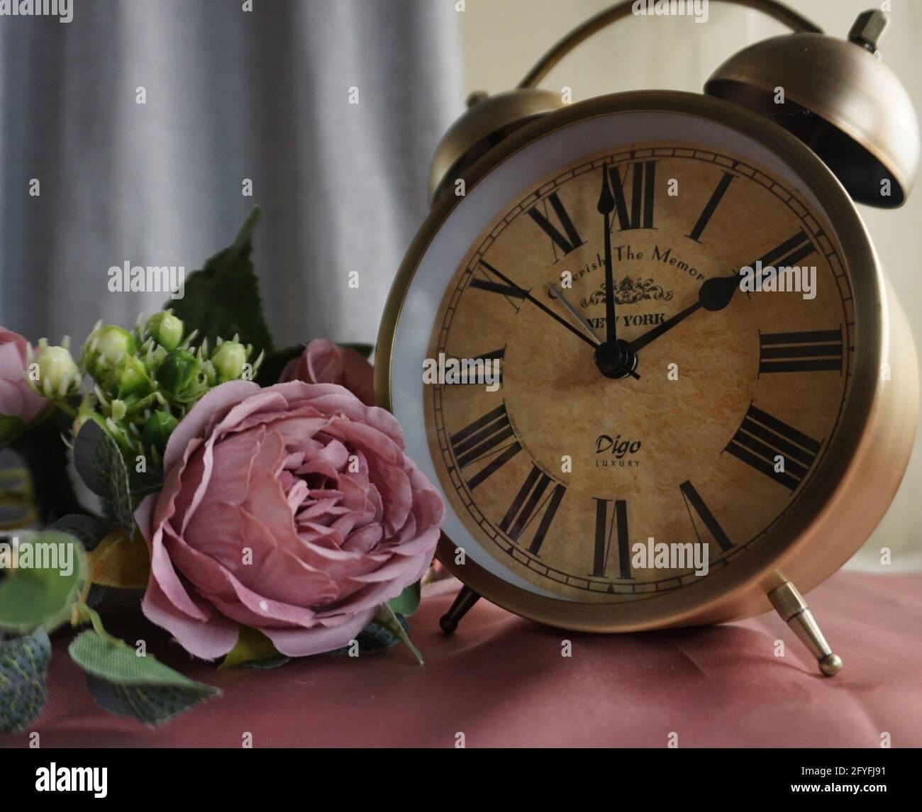 gold antique clock with pink roses Stock Photo - Alamy