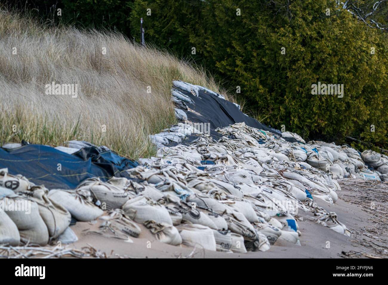 These sand filler coffee bags are an example of what homeowners are doing to combat the rising water levels along the shores of Lake Michigan. Stock Photo