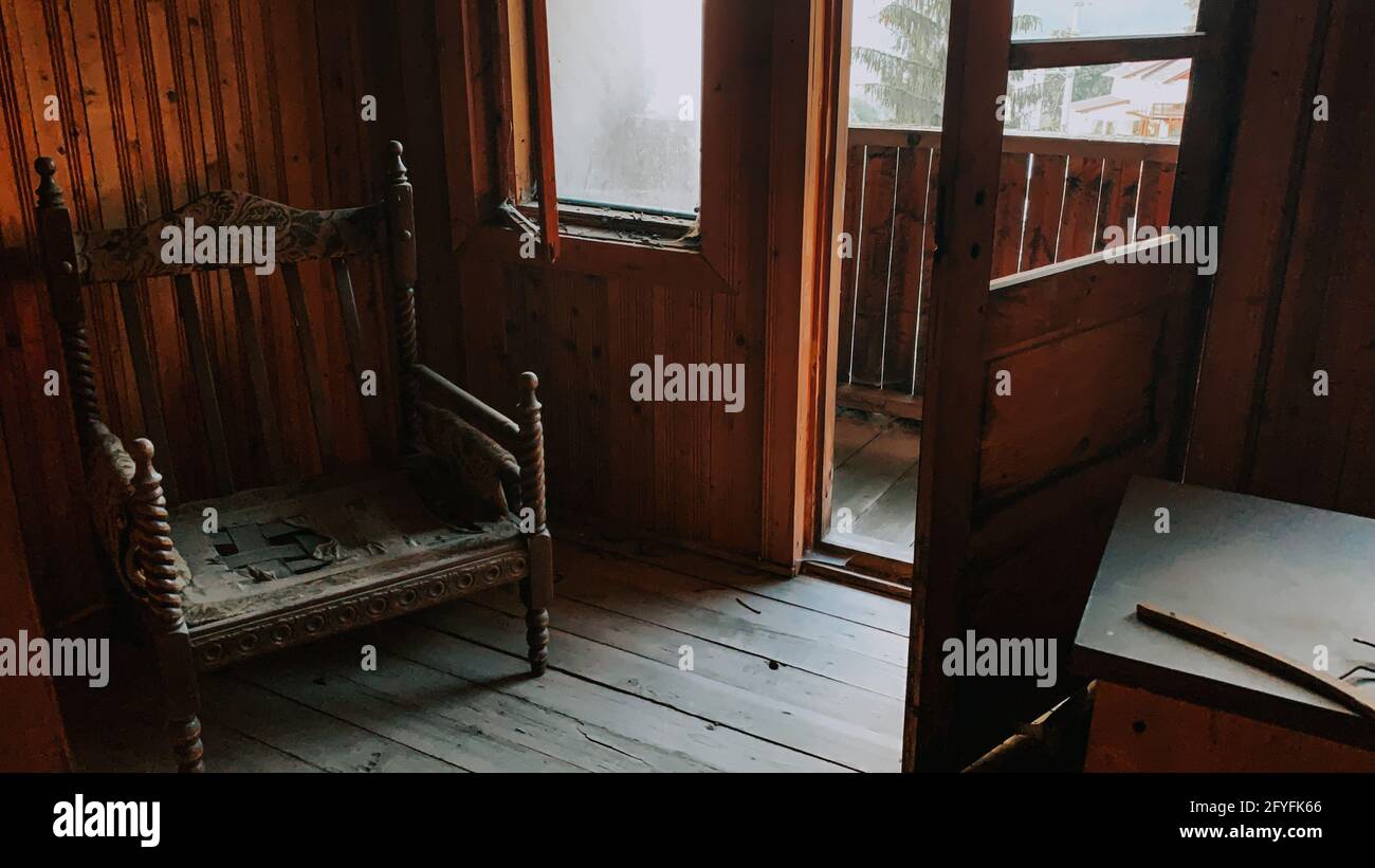 Vintage armchair inside an old wooden house Stock Photo - Alamy