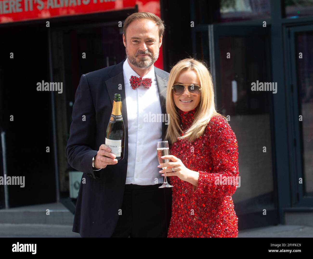 London, UK. 28th May, 2021. Amanda Holden leaves the offices of Global Radio and celebrates with Jamie Theakston after there was one lucky winner of One Million Pounds on their Miliion Pound quiz, 'Make me a Millionaire'. Shelley Humphries was the lucky winner. Credit: Mark Thomas/Alamy Live News Stock Photo