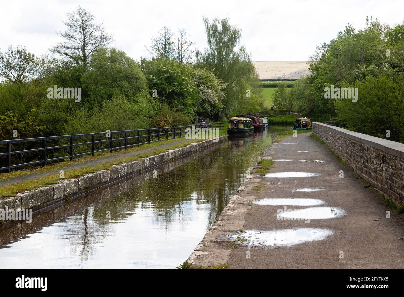 Narrowboats waiting to cross  the Brynich aqueduct, near Brecon on the Monmouthshire and Brecon Canal, Powys, Wales, UK Stock Photo