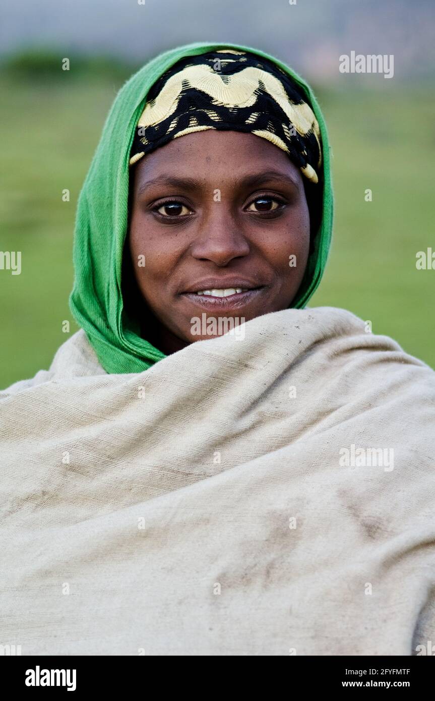 Ethiopian young woman smiling, veiled with a traditional cotton cloth
