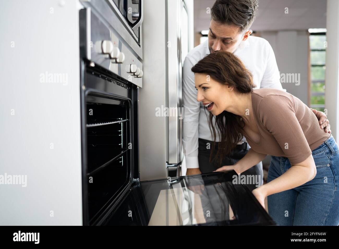 Couple Buying Electrical Oven With Consumer Loan Credit Stock Photo
