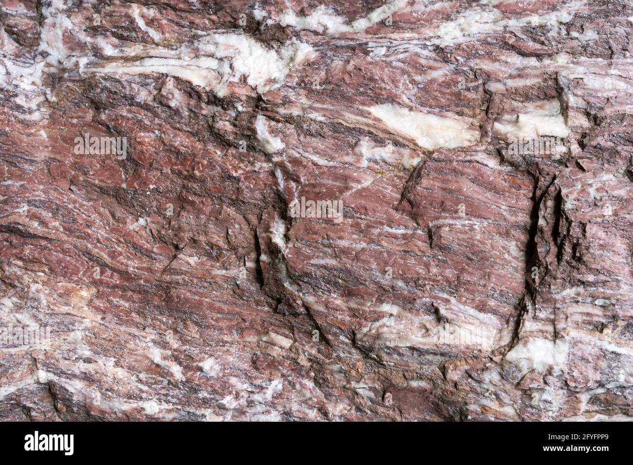 Red white natural stone with rough surface in close-up Stock Photo
