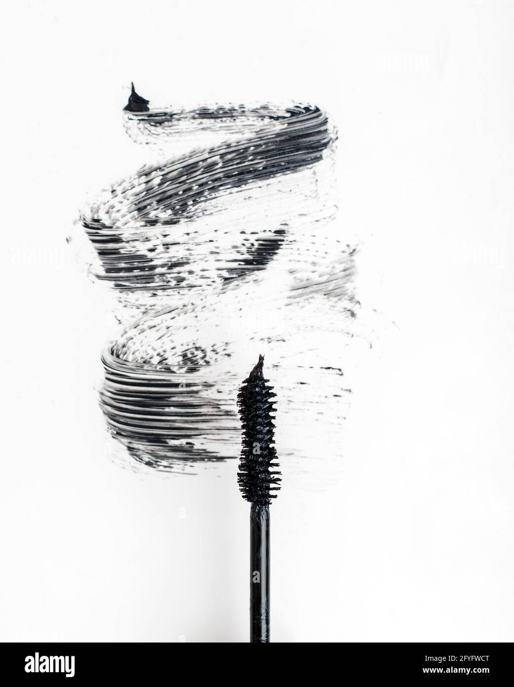 Black mascara on a white background. Stock Photo