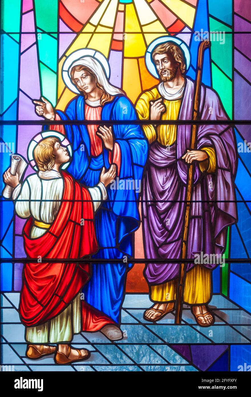 Christian scenes in stained glass following the catholic traditions, beautiful multicolor stained glass in Catholic church Stock Photo