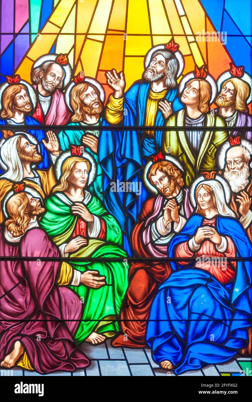 Holy Spirit Descent: Christian scenes in stained glass following the catholic traditions, beautiful multicolor stained glass in Catholic church Stock Photo