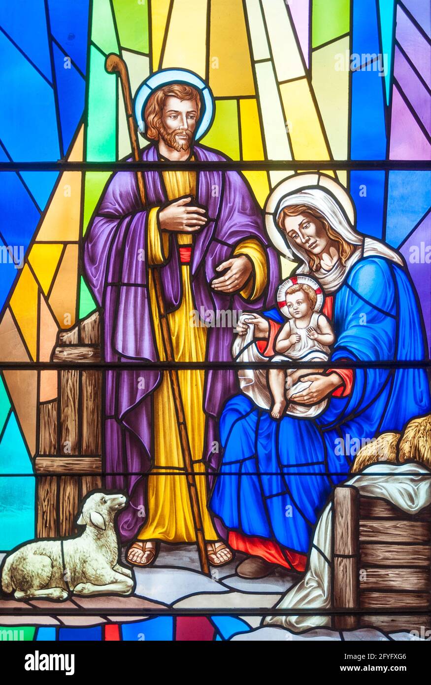 Nativity scene: Christian scenes in stained glass following the catholic traditions, beautiful multicolor stained glass in Catholic church Stock Photo