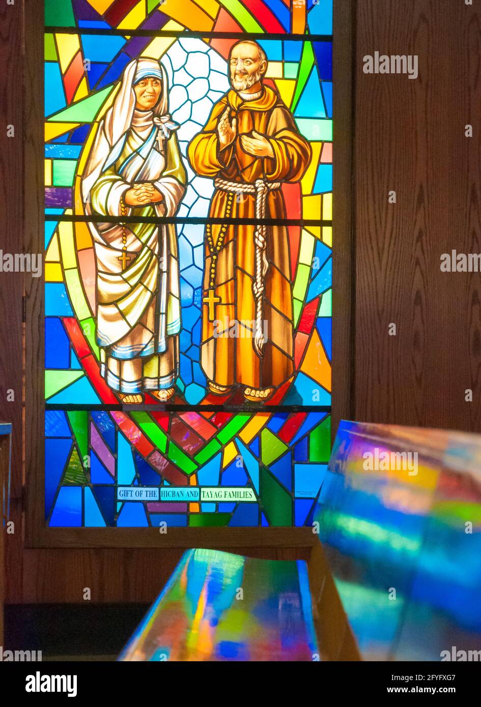 Catholic image in stained glass.  Joseph and the Virgin Mary are surrounded by the colorful glass at the Annunciation Catholic Church in Toronto.  The col Stock Photo