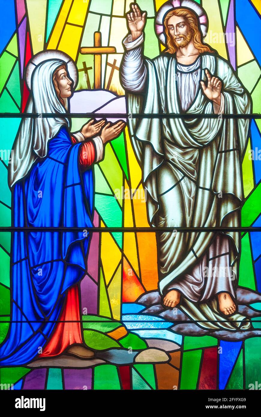 Christian scenes in stained glass following the catholic traditions, beautiful multicolor stained glass in Catholic church Stock Photo
