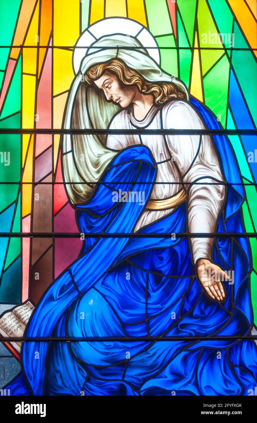 Christian scenes in stained glass following the catholic traditions, beautiful multicolor stained glass in a Catholic church Stock Photo